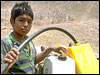 A boy with a donkey and water jugs.
ACDI-CIDA/Patricio-Baeza